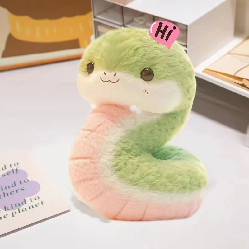 Plush kawaii toy snake with a 'Hi' tag on a light surface
