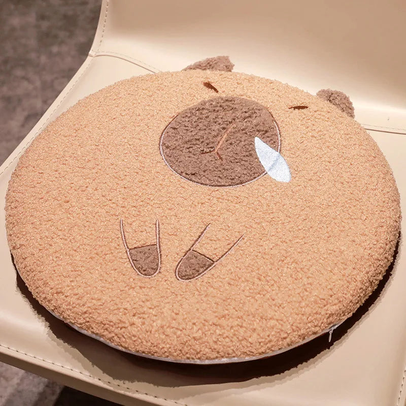 Round kawaii cushion with a bear face design on a beige surface