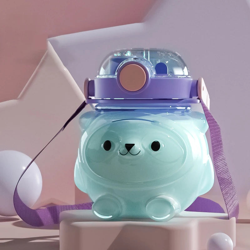 Cute animal-shaped kawaii water bottle with a purple lid on a pink background