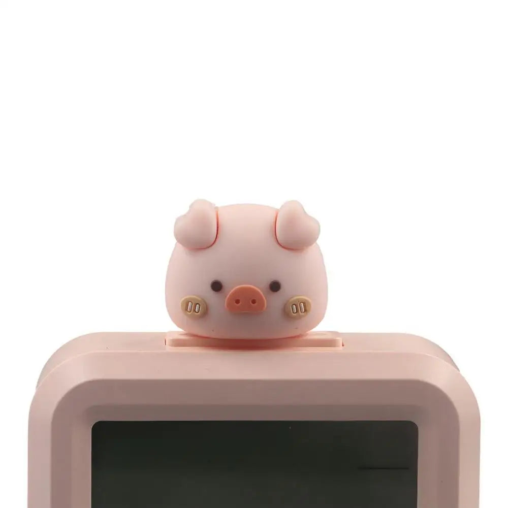 Pink kawaii pig-shaped device on a white background