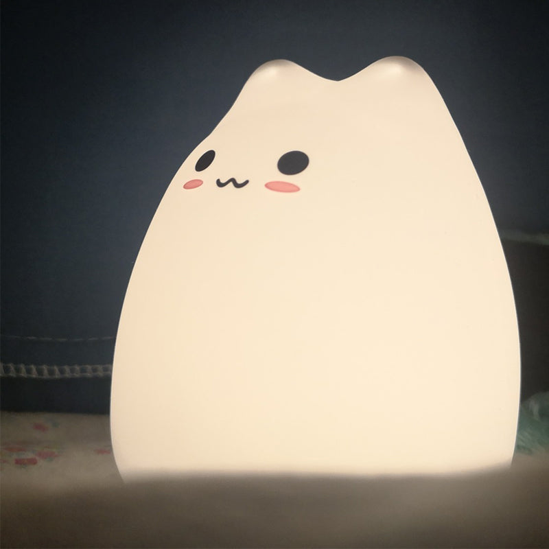 Cute kawaii cat-shaped night light on a dark background