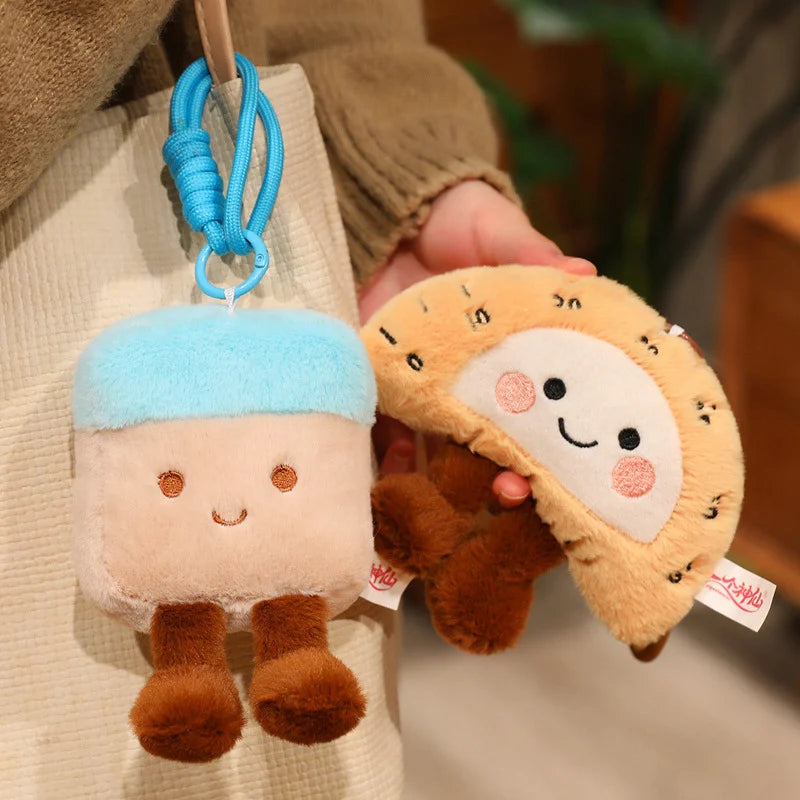 Two kawaii plush keychains, one resembling a sheep and the other a cookie, held against a neutral background.