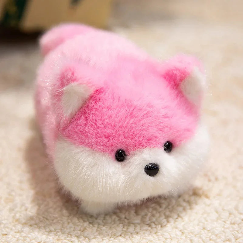 Small kawaii plush toy with a pink face and white body on a beige surface