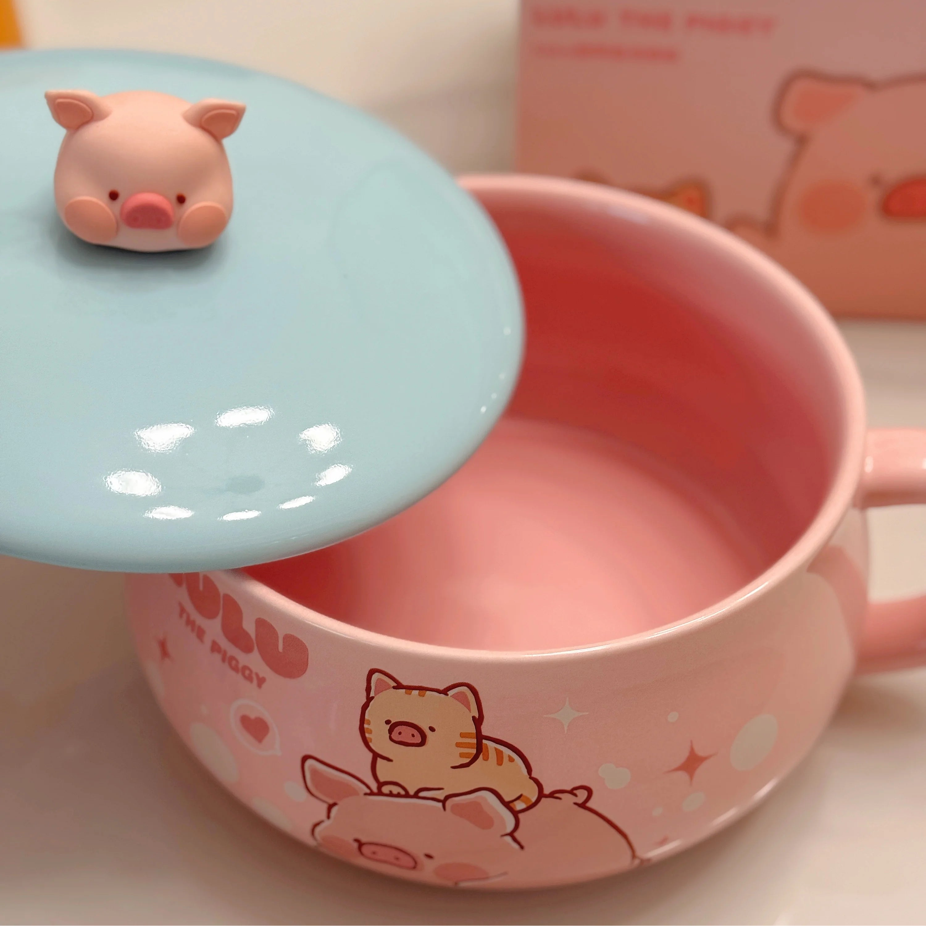 A pink ceramic kawaii ramen bowls with a blue lid