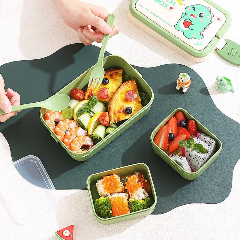 Green kawaii bento box with various food items on a white background