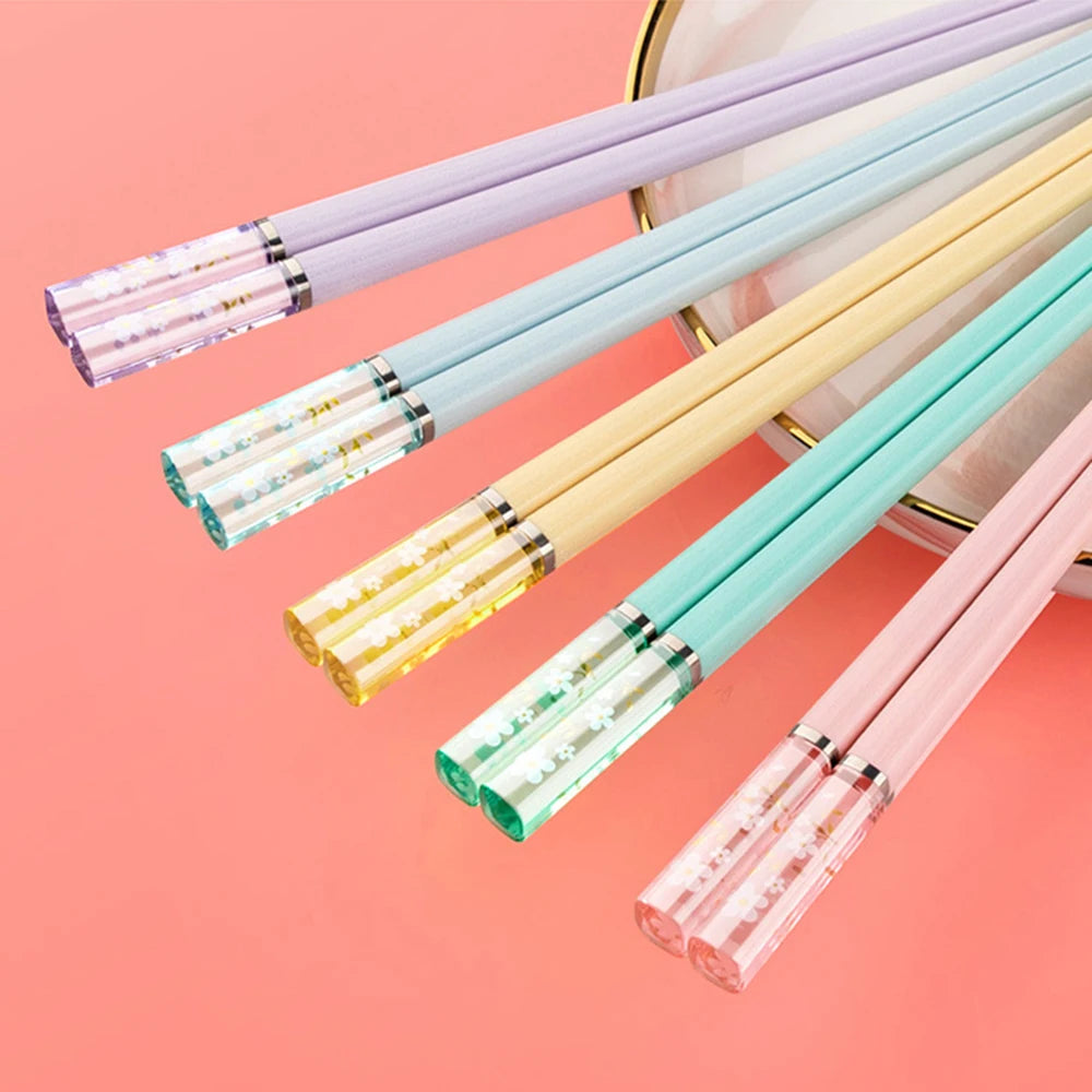 Set of colorful kawaii chopsticks on a pink background