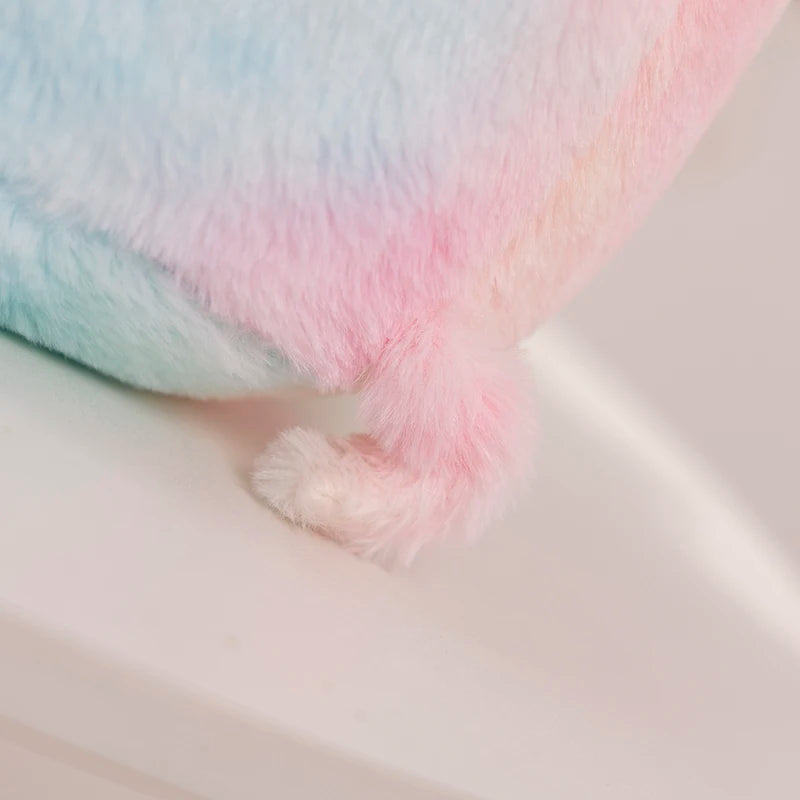 A close up of a kawaii plush toy shaped like a pig's tail