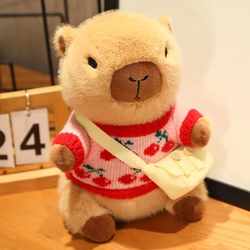 Kawaii plush bear toy wearing a red sweater with floral patterns on a wooden surface.