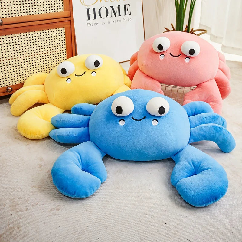 Three colorful kawaii plush crab toys on a light surface with a blurred background