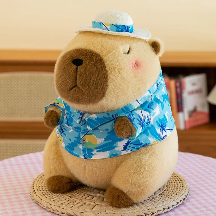 Kawaii plush teddy bear wearing a blue floral shirt and hat on a pink checkered tablecloth.
