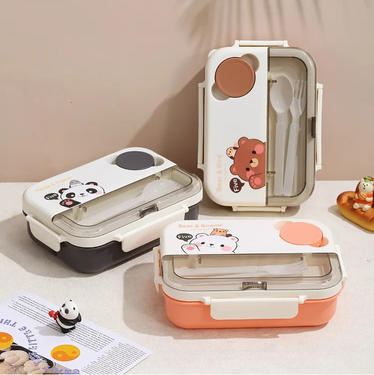 Three cartoon-themed kawaii lunch boxes on a light surface with a neutral background