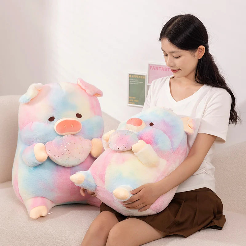 A woman holding a rainbow colored kawaii pig plush toy