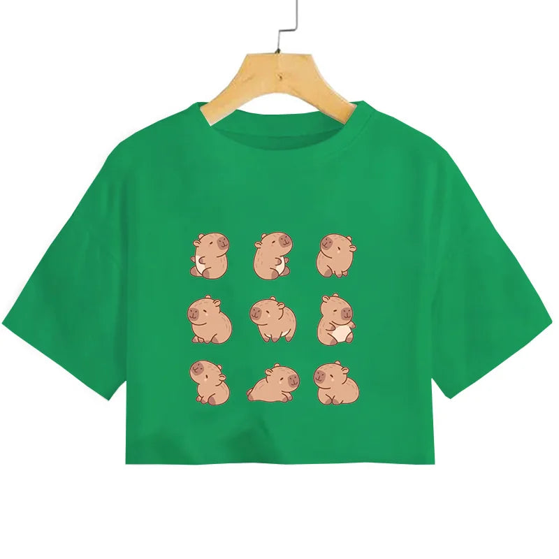 Green t-shirt with kawaii cartoon pig designs on a hanger against a white background