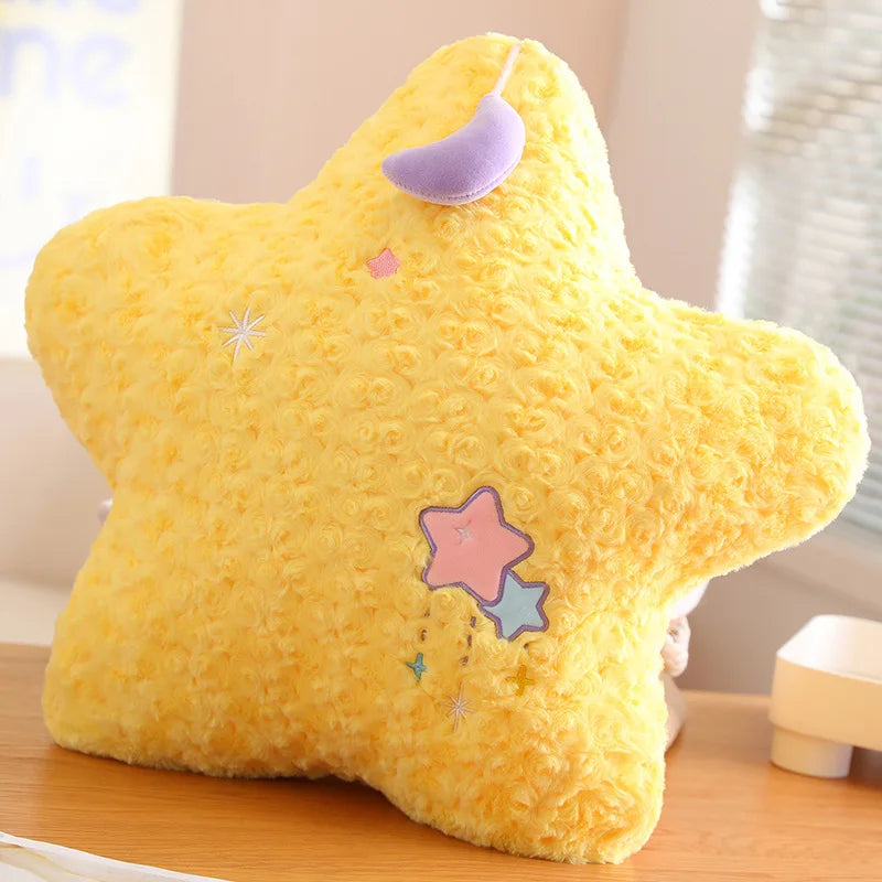 Yellow star-shaped kawaii plush toy with decorative elements on a wooden surface.