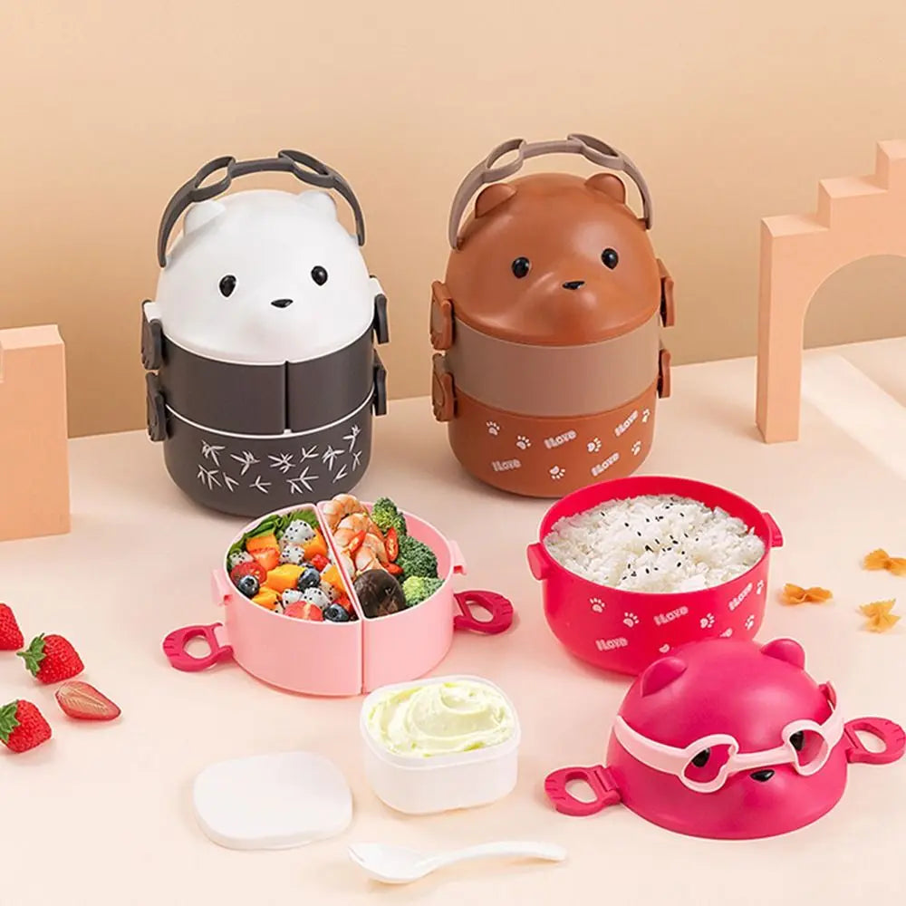 Set of cartoon-themed kawaii lunch boxes on a light pink background