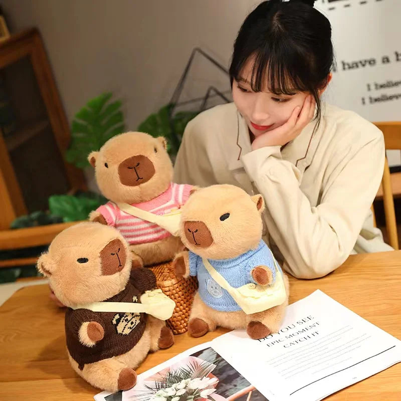 Woman sitting at a table with three kawaii teddy bears wearing different outfits.