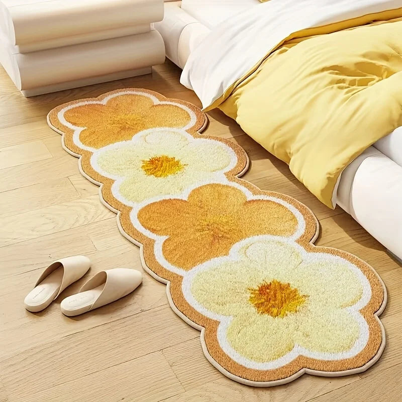 Floral-patterned kawaii rug on a wooden floor with a bed and slippers in the background