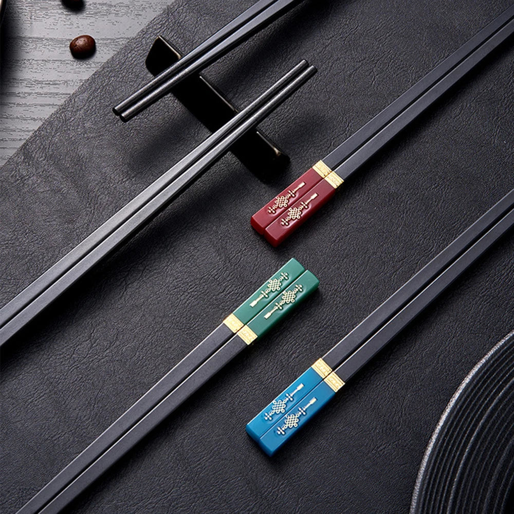 Set of kawaii chopsticks with decorative handles on a dark surface