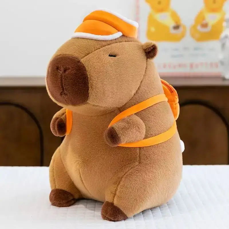 Kawaii plush bear toy wearing an orange outfit on a white surface with a blurred background