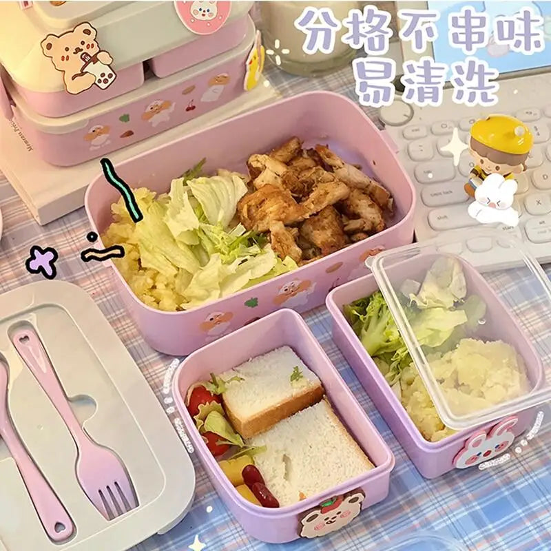 Pink kawaii bento box with compartments containing food on a checkered tablecloth.