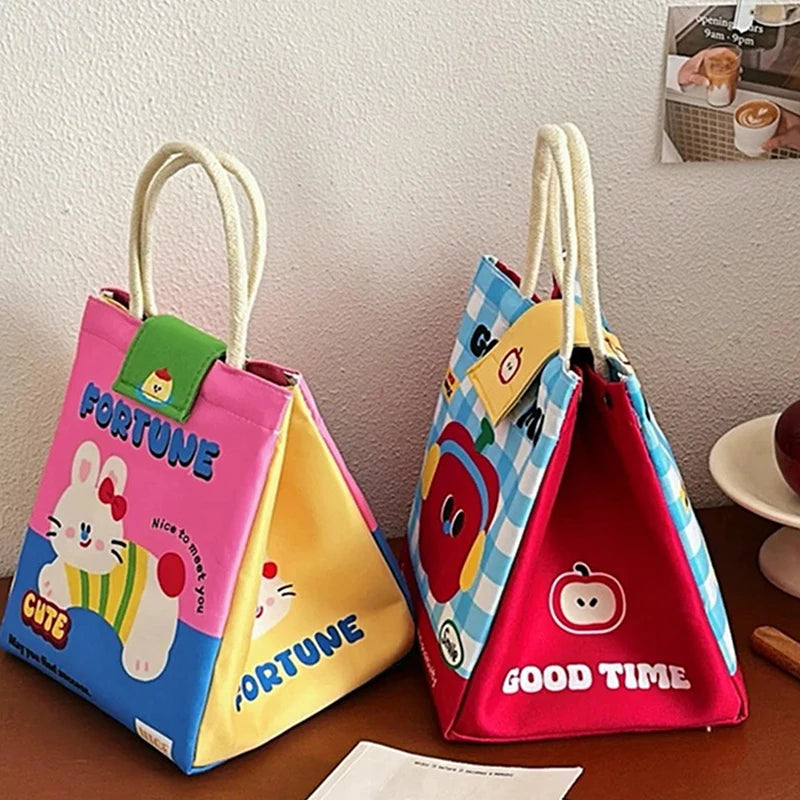 Two colorful children's kawaii bags with cartoon designs on a wooden surface.