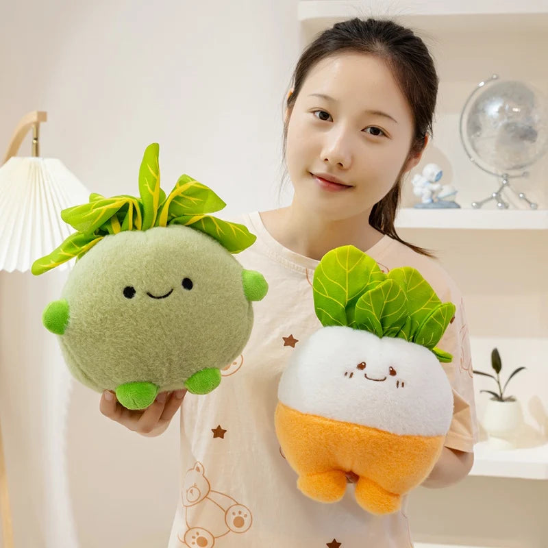 Person holding two kawaii plush vegetables, one green and one orange, against a neutral background.