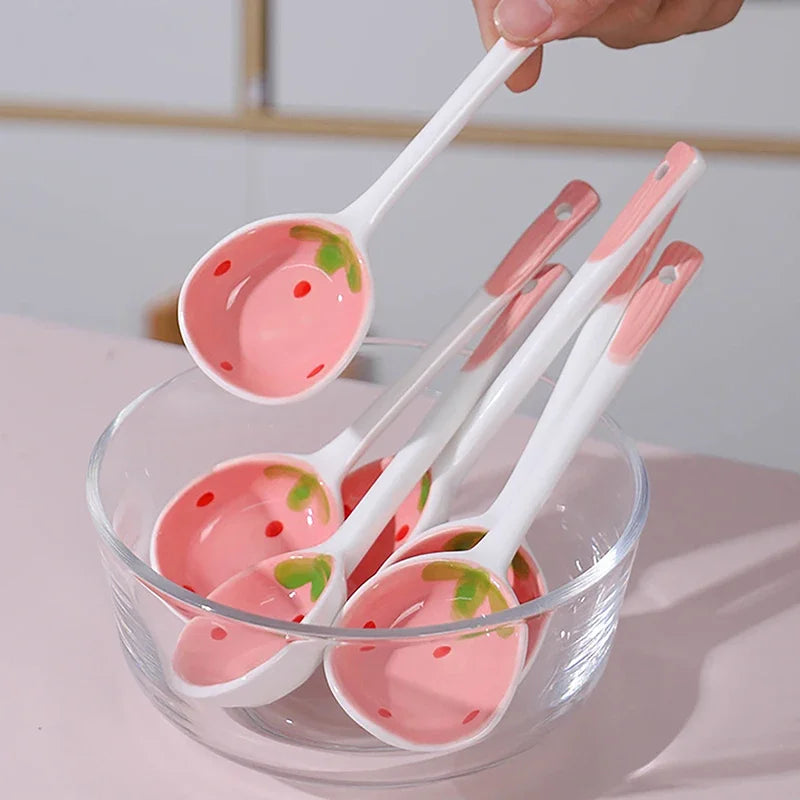 A person holding a strawberry designed kawaii spoon