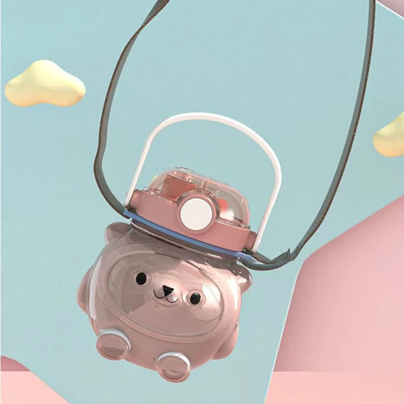 Pink bear-shaped kawaii water bottle with a string on a light blue background