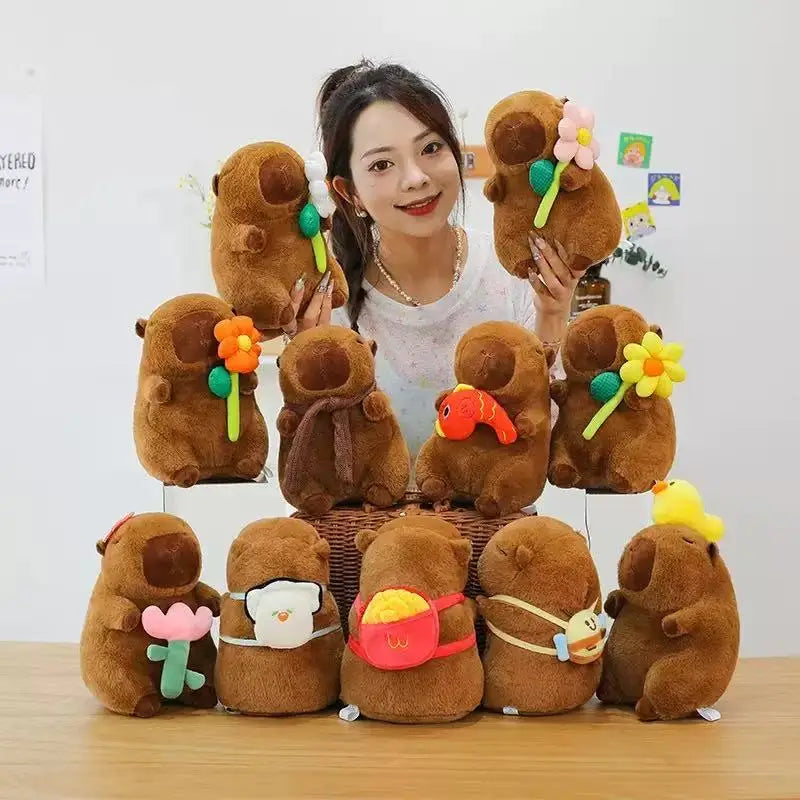 Woman with a collection of small brown kawaii plush toys on a table.