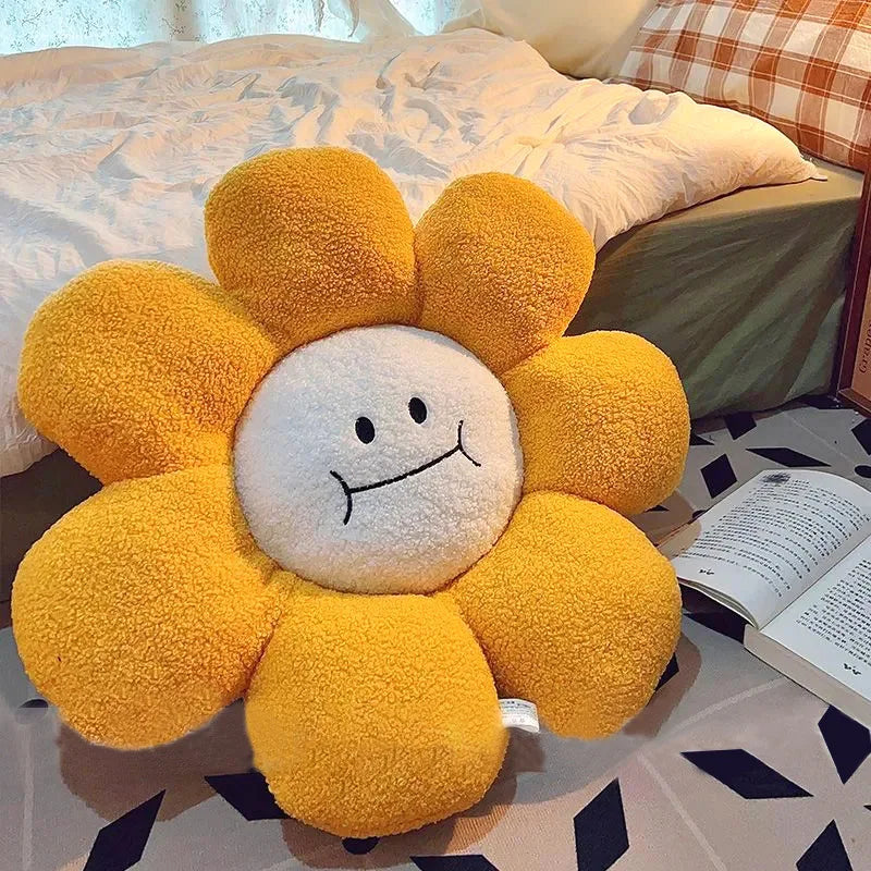 Yellow flower-shaped kawaii plush toy on a bed with an open book