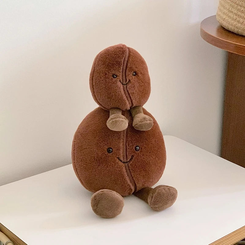 Brown kawaii plush toy resembling a bear with a smiling face on a white surface.