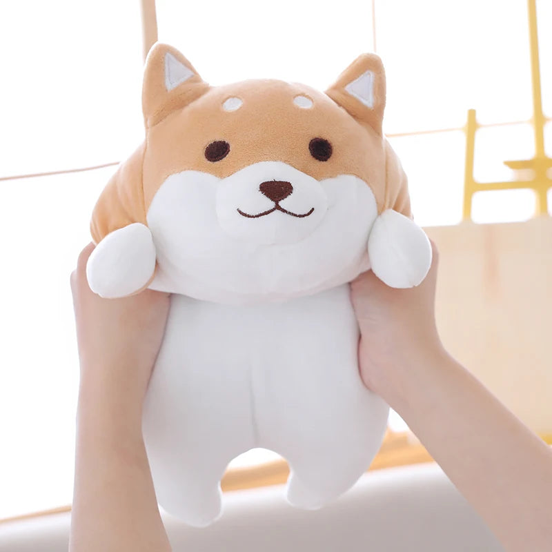 Cute plush kawaii toy shaped like a dog held by a person against a neutral background