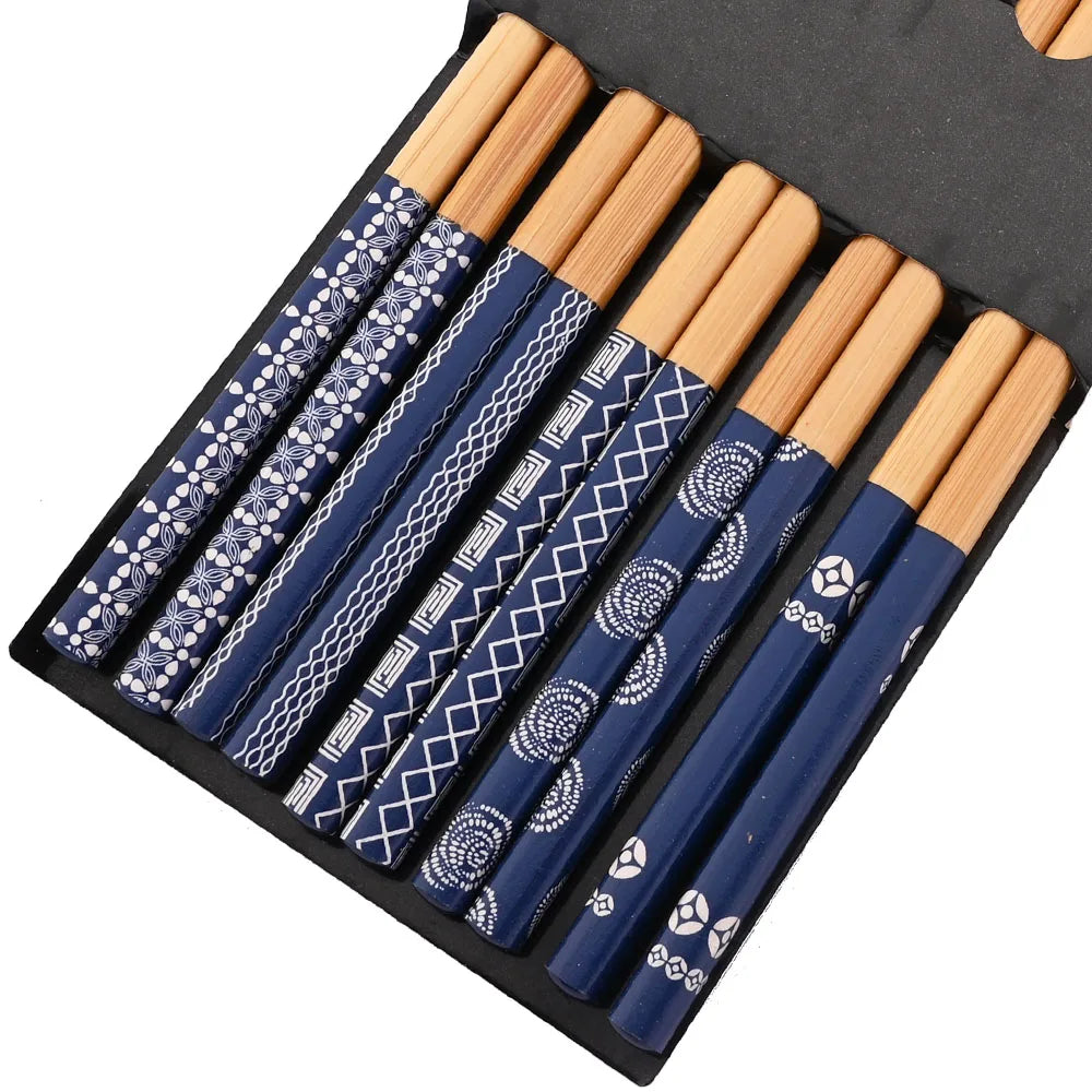 Set of blue patterned kawaii chopsticks with wooden handles in a black case.