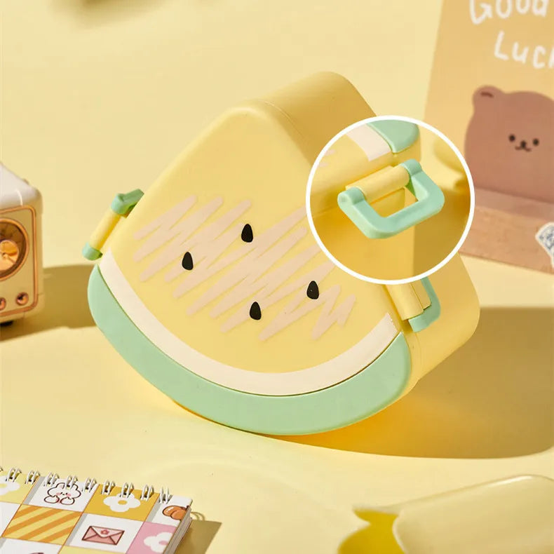 Yellow and green children's kawaii bento box with a bear design on a yellow background