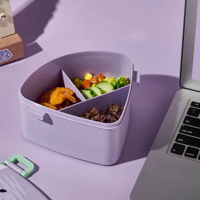 Kawaii lunch box with food items on a desk next to a laptop, with text indicating it's nutritious and suitable for office use.