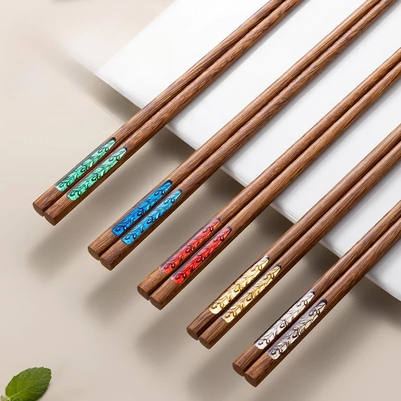 Set of wooden kawaii chopsticks with decorative ends on a beige background
