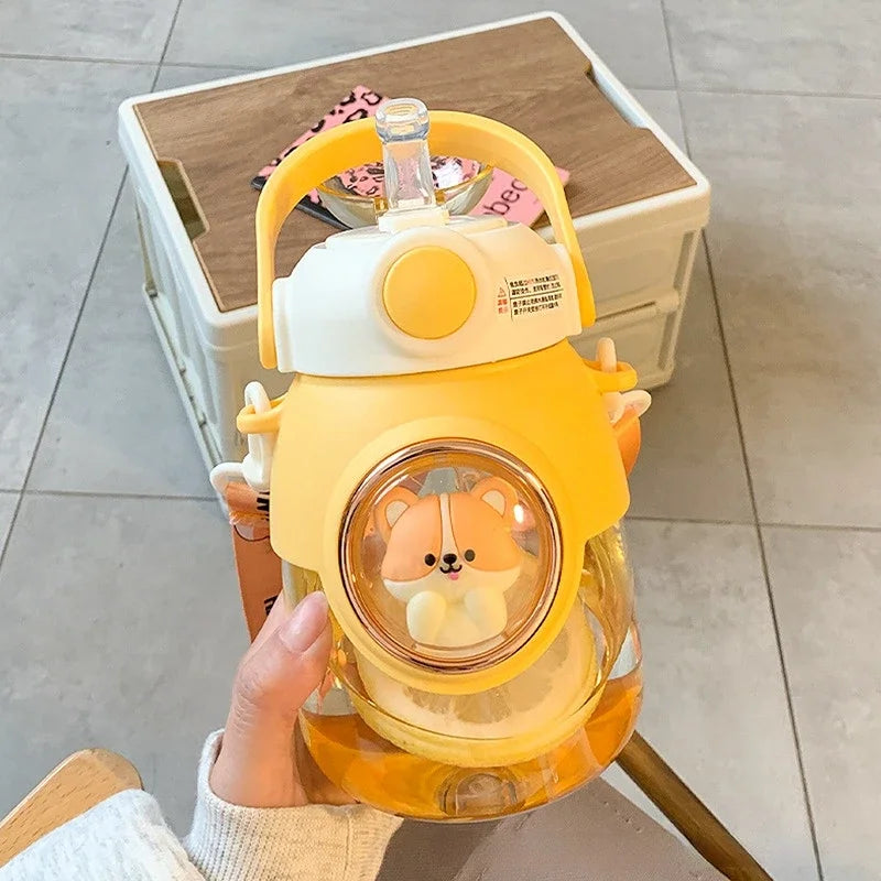 Cute yellow kawaii water bottle with a small animal toy inside, held by a person.