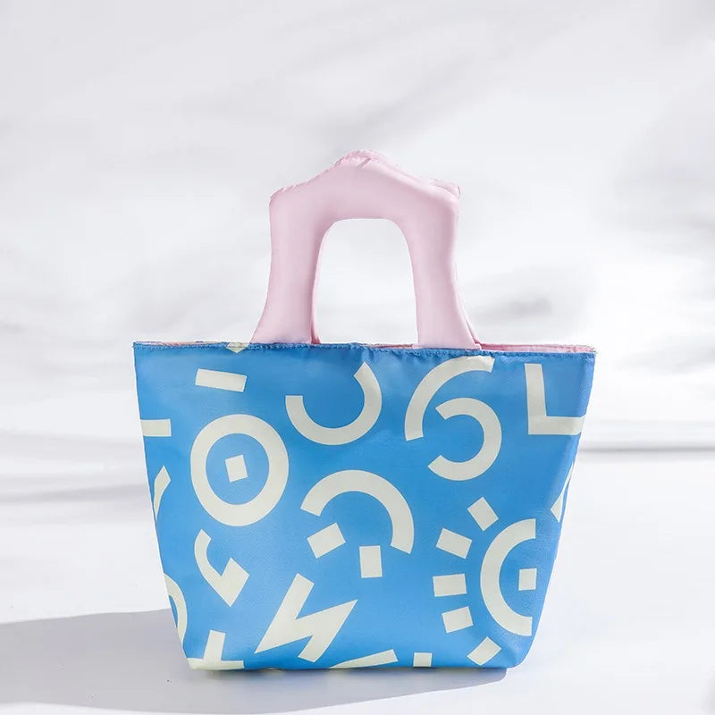 Blue kawaii tote bag with white geometric pattern on a light gray background