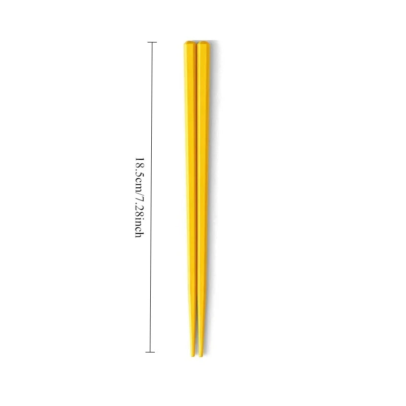 Yellow kawaii chopsticks with measurement details on a white background