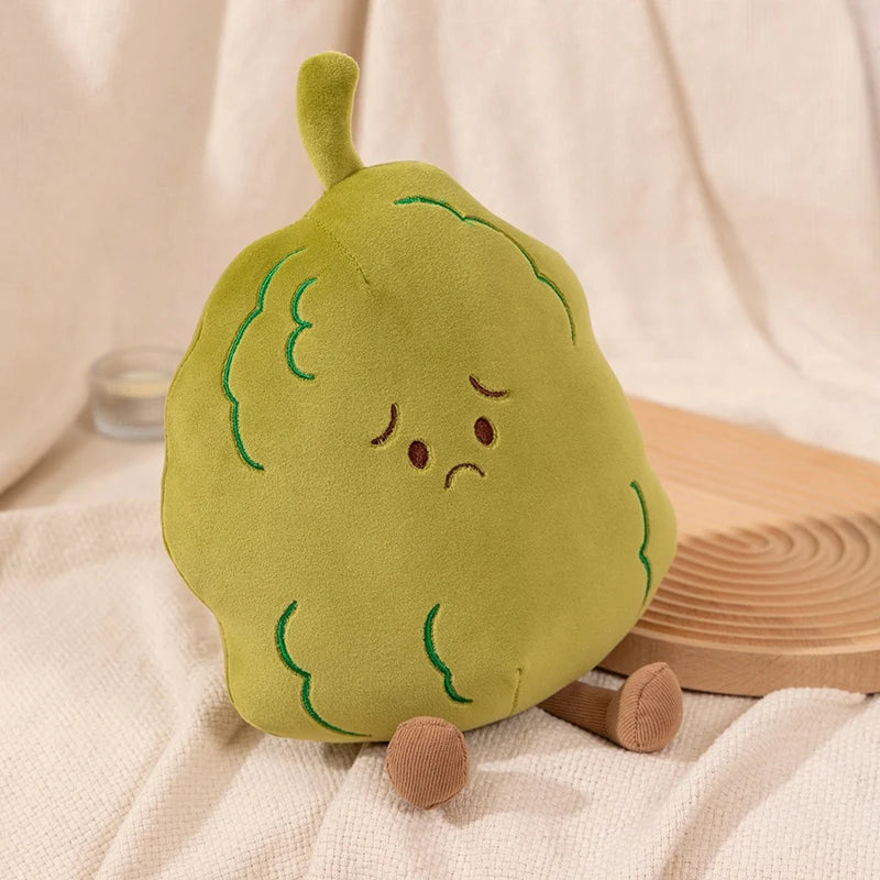 Plush toy shaped like a pear with a sad expression on a beige background