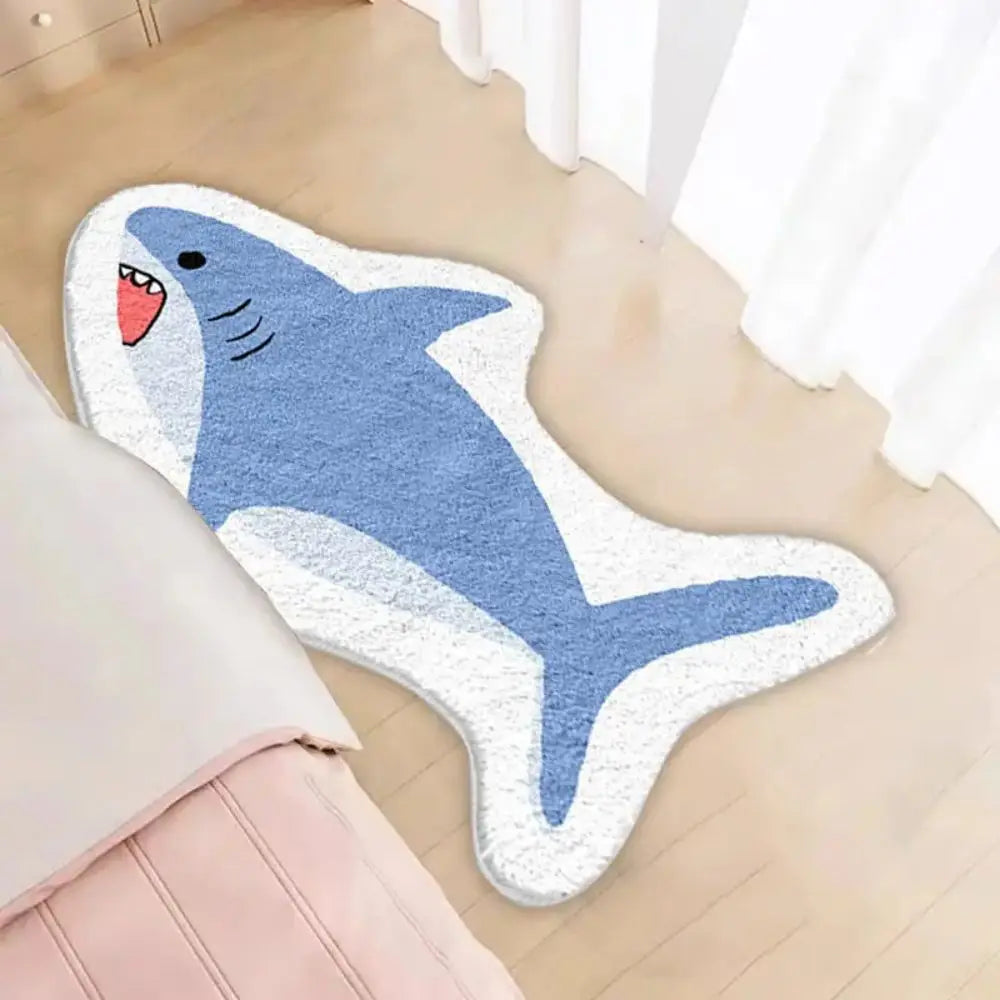 Shark-shaped kawaii bath mat on a wooden floor