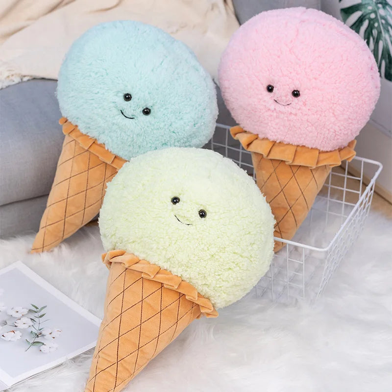 Three kawaii plush ice cream cones in pastel colors on a light surface.