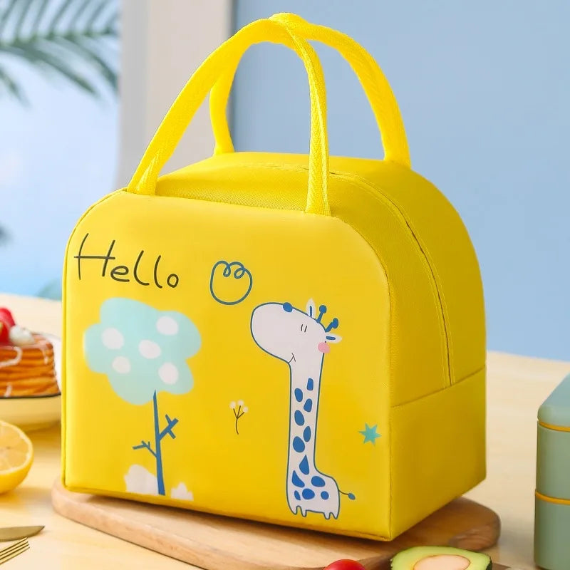 Yellow kawaii lunch bag with a giraffe design and 'Hello' text on a table.