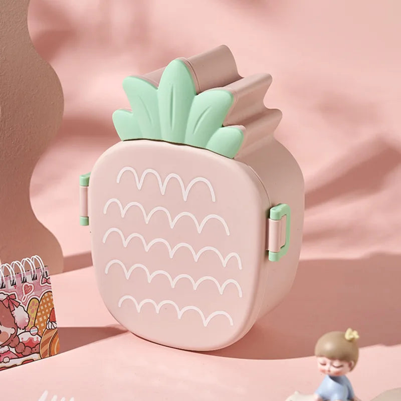 Pink pineapple-shaped kawaii food container on a pink background