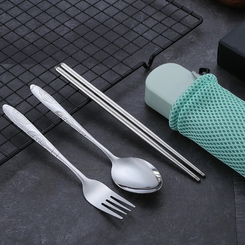A set of steel kawaii utensils next to a green case