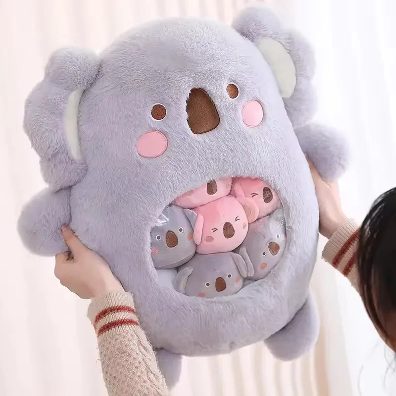 Kawaii plush toy shaped like a koala with smaller koalas inside, held by a person.