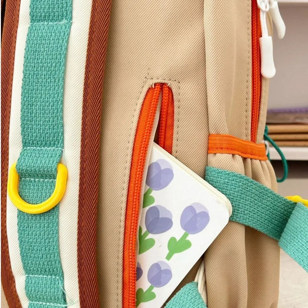 Close-up of a backpack with Kawaii colorful straps and a floral card attached.