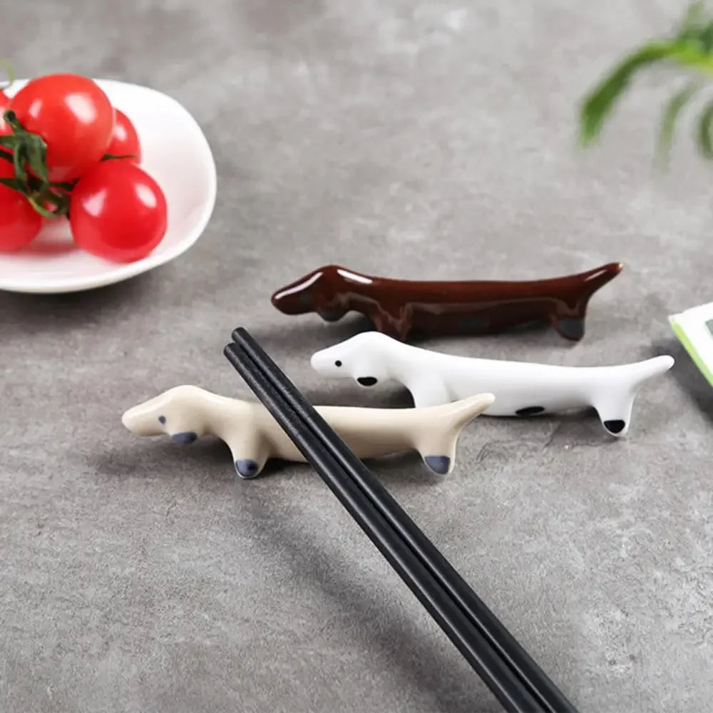 Three dog shaped kawaii chopstick holders on a table