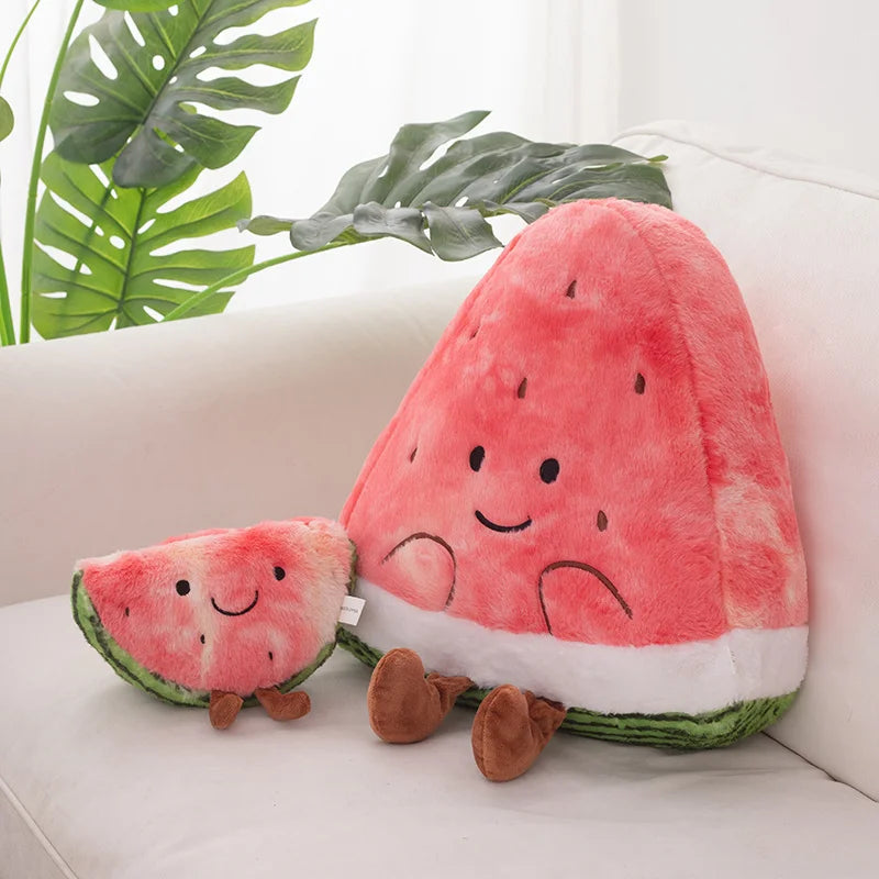 Kawaii plush watermelon toys on a white surface with green leaves in the background