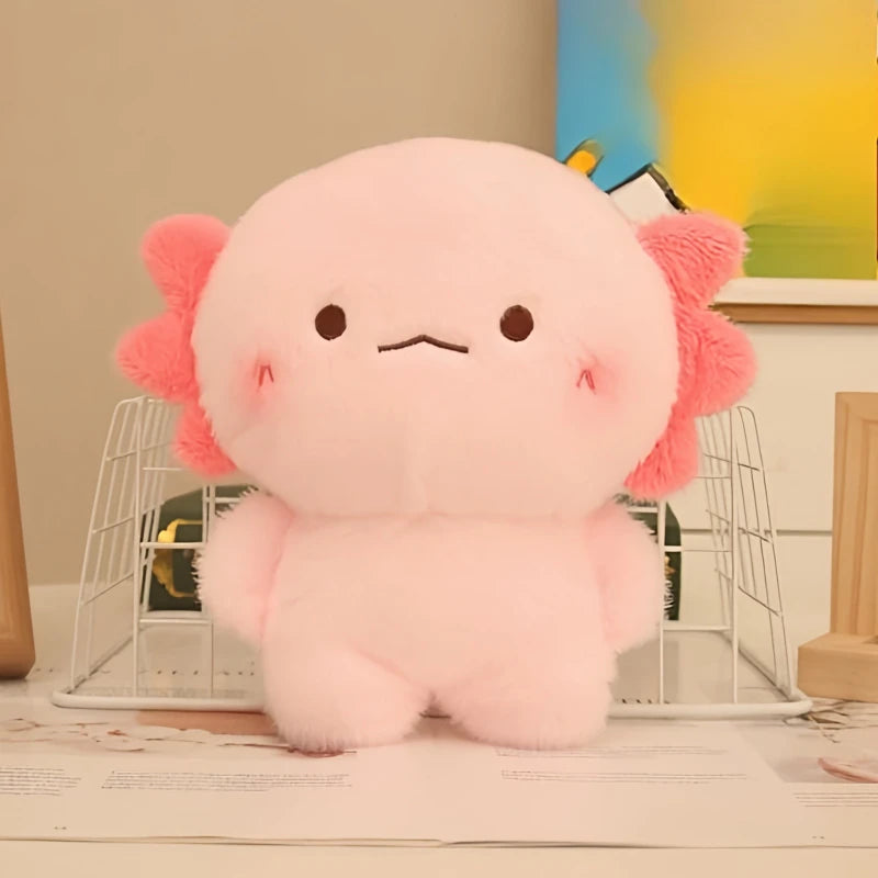 Pink kawaii plush toy with flower-like ears on a desk